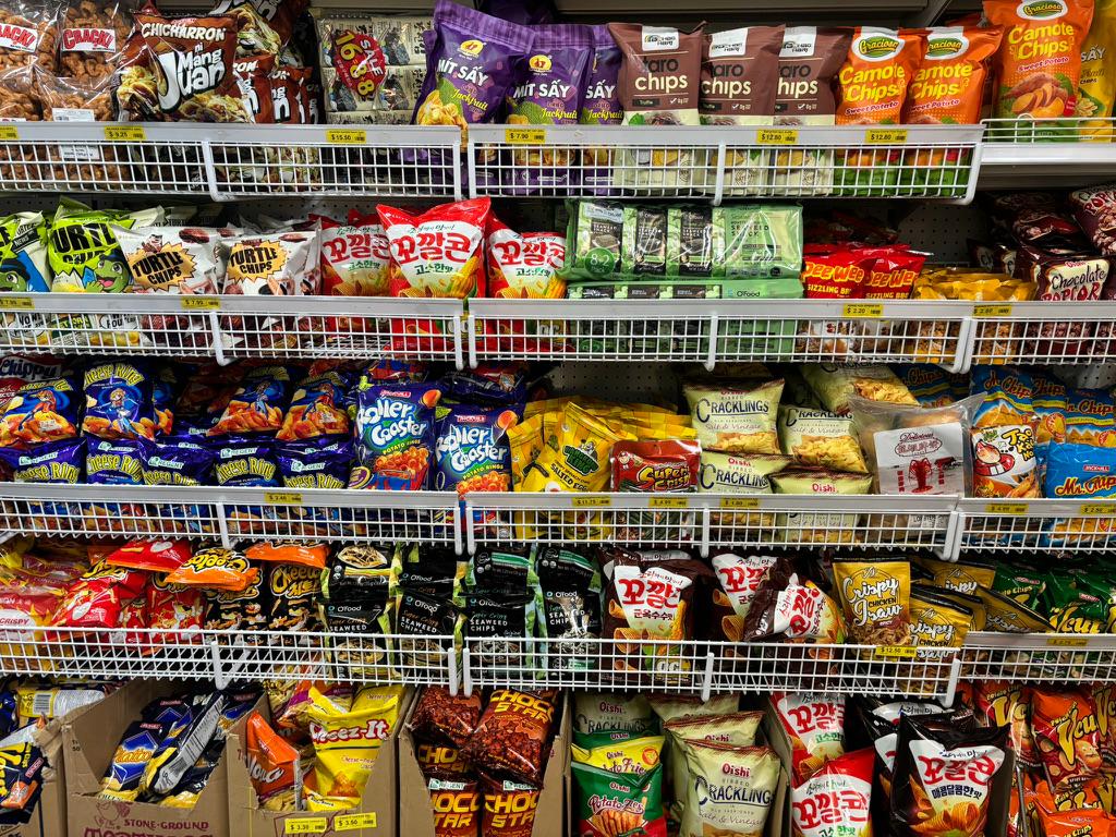 Shelf packed with Asian snacks and chips inside Filmart Asian Shop